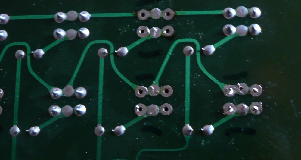 Solder pins protruding through board